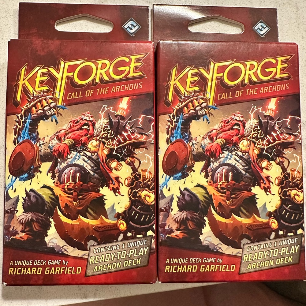 Two packs of KeyForge cards